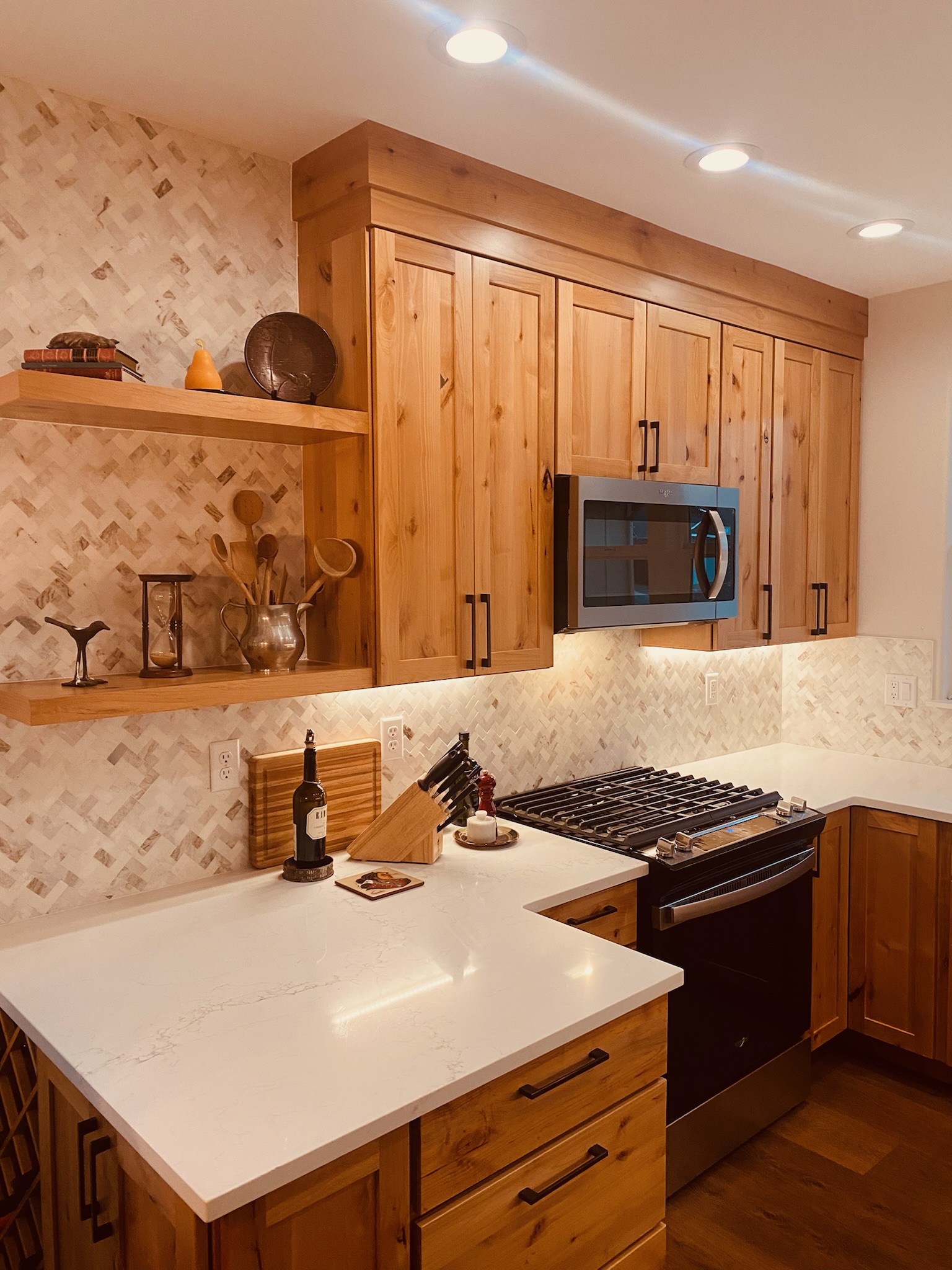 Beautiful lighting and counter to ceiling tile in this kitchen remodel.